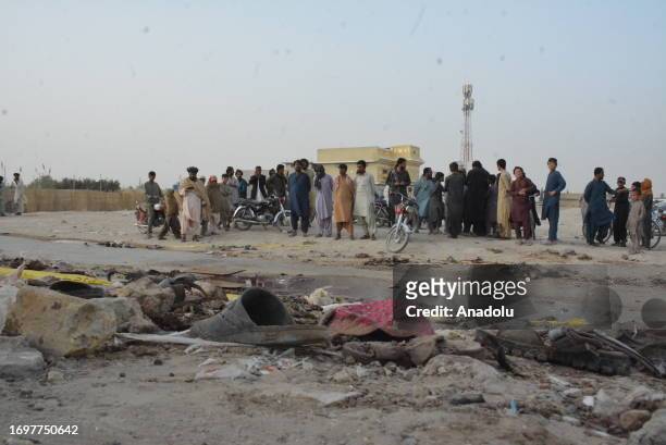 People inspect the site of the bomb blast at a mosque in Mastung town in the Balochistan province of Pakistan on September 29, 2023. At least 50...