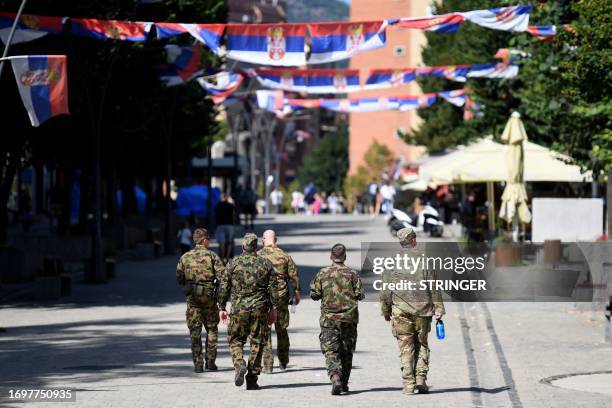 Led international peacekeeping force the Kosovo Force soldiers walk in the northern part of the ethnically divided city of Mitrovica, on September...