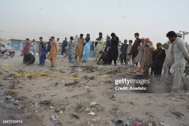 People inspect the site of the bomb blast at a mosque in Mastung town in the Balochistan province of Pakistan on September 29, 2023. At least 50...