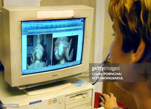 Bangkok resident views Thai antiques on an internet auction site 05 November 1999. Southeast Asia faces a new front in the battle against the illegal...