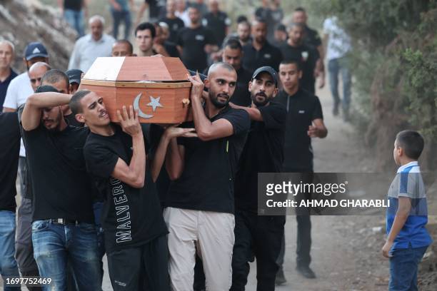 Mourners carry a coffin during the funeral of five Arab Israelis who were shot dead in the town of Basmat Tabun, in northern Israel on September 29,...