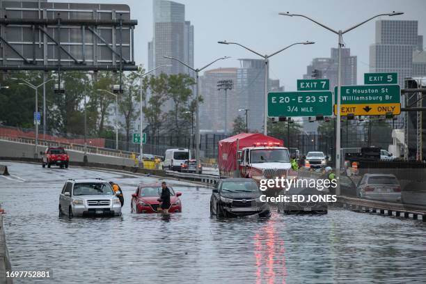 Cars in floodwater on the FDR highway in Manhattan, New York on September 29, 2023. Heavy rains overnight in the northeastern United States left...