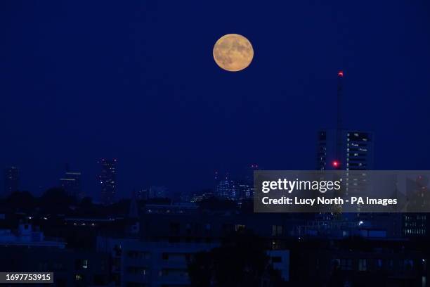 Supermoon is visible above the London skyline. The moon will be near its closest approach to the Earth and may look slightly larger and brighter than...