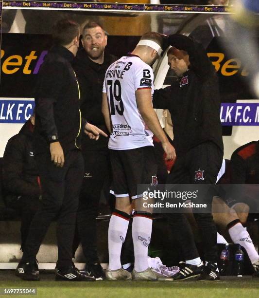 Louth , Ireland - 29 September 2023; Darren Brownlie of Dundalk has an injury to his head wrapped by Dundalk team doctor Dr Danny Miller after being...