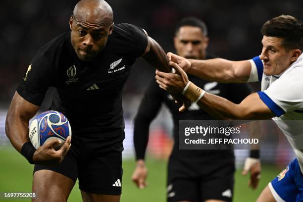 New Zealand's left wing Mark Telea runs to score a try as he evades Italy's full-back Tommaso Allan during the France 2023 Rugby World Cup Pool A...