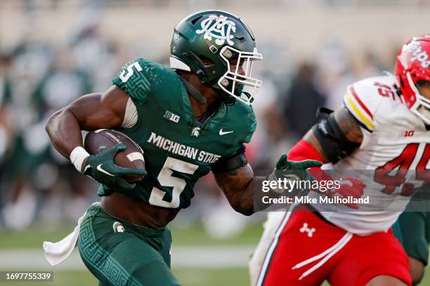 Nathan Carter of the Michigan State Spartans runs up the field in the fourth quarter of a game against the Maryland Terrapins at Spartan Stadium on...