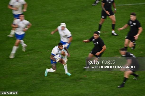 Italy's left wing Monty Ioane runs with the ball during the France 2023 Rugby World Cup Pool A match between New Zealand and Italy at the OL Stadium...