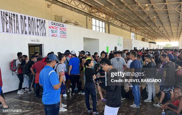 Migrants wait to buy bus tickets at the bus station in the city of Juchitan, Oaxaca State, on September 29, 2023. In the last 11 months, at least 1.8...