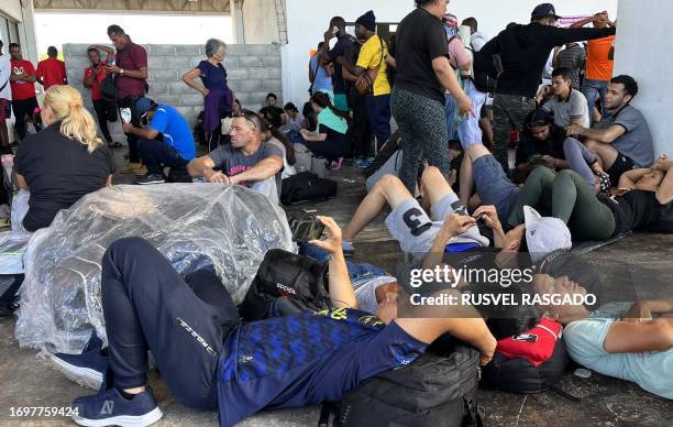 Migrants wait to buy bus tickets at the bus station in the city of Juchitan, Oaxaca State, on September 29, 2023. In the last 11 months, at least 1.8...