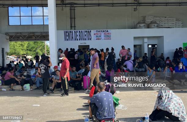 Migrants wait to buy bus tickets at the bus station in the city of Juchitan, Oaxaca State, on September 29, 2023. In the last 11 months, at least 1.8...