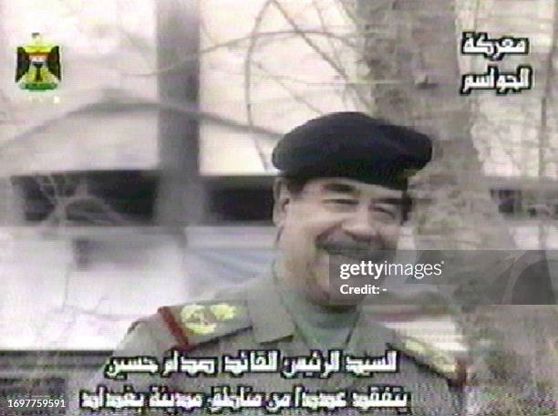 In this image taken off Iraqi television satellite channel 04 April 2003, Iraqi President Saddam Hussein is seen smiling as he greets the crowds...