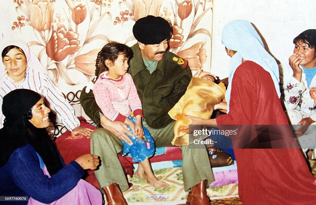 Sadam Rashka -- Iraqi President Saddam Hussein visits a peasant family in the ...