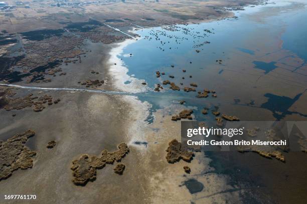 An aerial view of a large area of Lake Titicaca affected by the drought on September 29, 2023 in Huarina, Bolivia. Water level of Titicaca Lake, the...