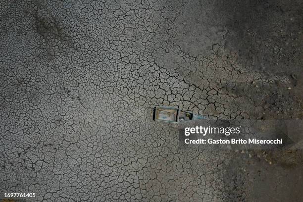 An aerial view of a stuck boat on the dried Lake Titicaca's bed due to the drought on September 29, 2023 in Huarina, Bolivia. Water level of Titicaca...