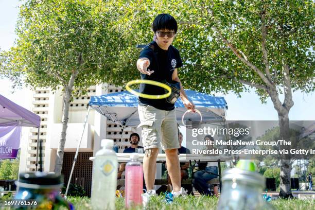 Kiran Sui plays a ring toss game at a club informational booth during the first day of the fall semester at UC Riverside campus on Thursday, Sept....