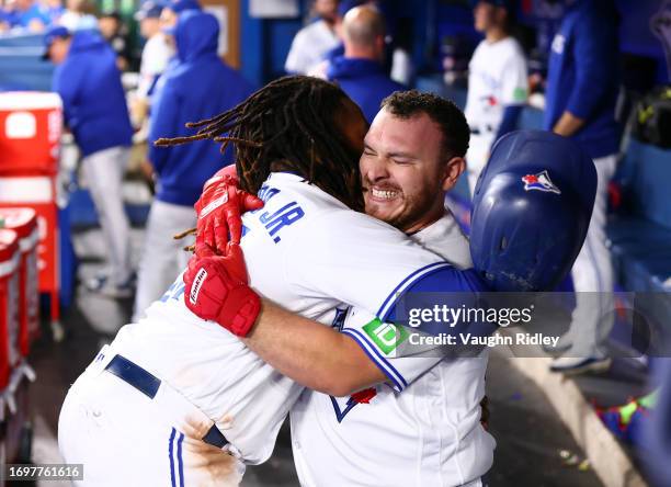Alejandro Kirk of the Toronto Blue Jays celebrates with Vladimir Guerrero Jr. #27 after hitting a home run in the second inning against the Tampa Bay...