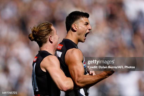 Nick Daicos of the Magpies celebrates a goal with teammate Beau McCreery of the Magpies during the 2023 AFL Grand Final match between the Collingwood...