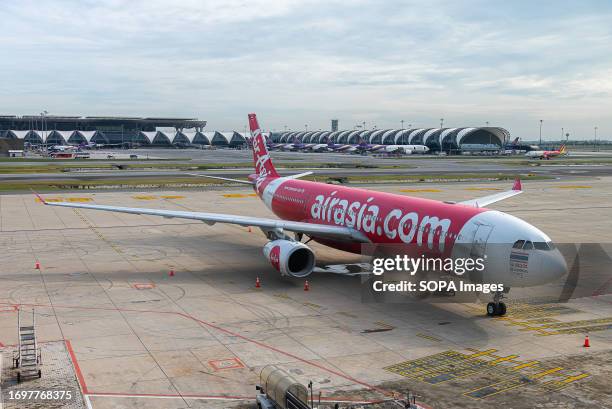 An Air Asia plane seen outside the SAT-1 terminal at the Suvarnabhumi International Airport in Samut Prakarn. The new SAT-1 terminal at Suvarnabhumi...