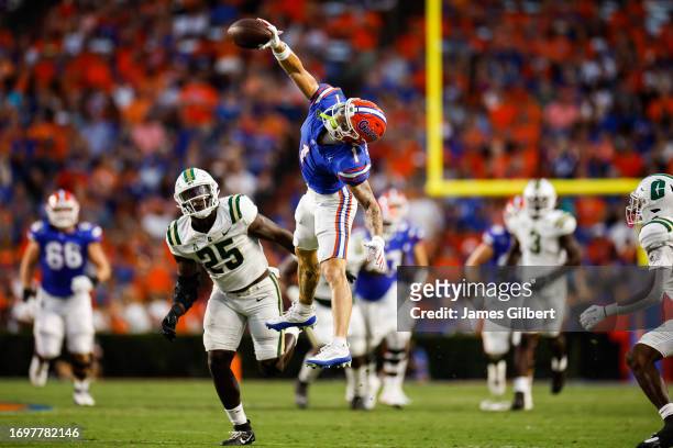 Ricky Pearsall of the Florida Gators catches a pass against Prince Bemah of the Charlotte 49ers during the first halfof a game at Ben Hill Griffin...