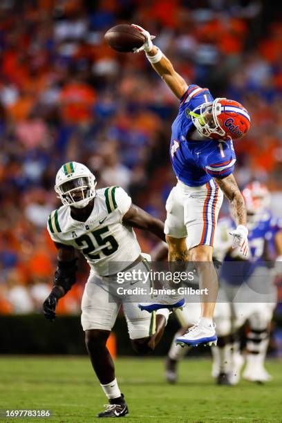 Ricky Pearsall of the Florida Gators catches a pass against Prince Bemah of the Charlotte 49ers during the first halfof a game at Ben Hill Griffin...