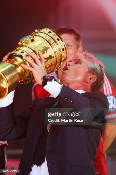 Jupp Heynckes head coach of Bayern Muenchen lifts the trophy to celebrate victory in his last match after the DFB Cup Final match between FC Bayern...
