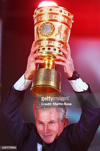 Jupp Heynckes head coach of Bayern Muenchen lifts the trophy to celebrate victory in his last match after the DFB Cup Final match between FC Bayern...