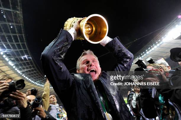 Bayern Munich's head coach Jupp Heynckes celebrates with the trophy after they won the final football match of the German Cup FC Bayern Munich vs VfB...