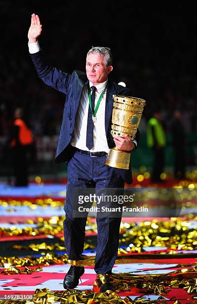 Jupp Heynckes head coach of Bayern Muenchen holds the trophy to celebrate victory in his last match after the DFB Cup Final match between FC Bayern...