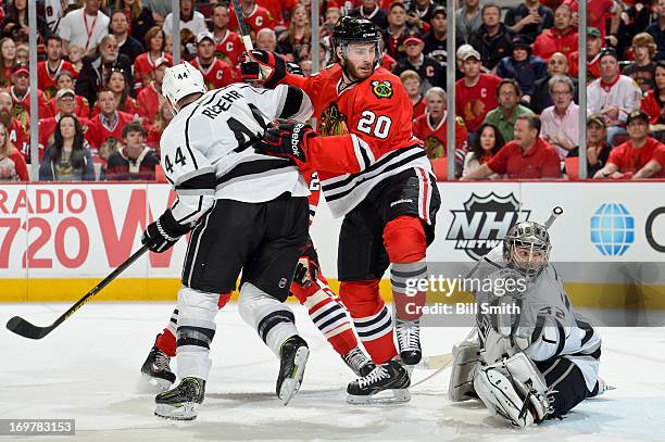 Brandon Saad of the Chicago Blackhawks watches for the puck in between Davis Drewiske and goalie Jonathan Quick of the Los Angeles Kings in Game One...