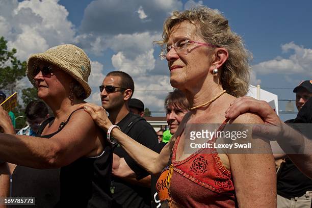 Marilyn Vogt-Downy from Brooklyn, N.Y., center, and others gather for a mass rally in support for PFC Bradley Manning on June 1, 2013 in Fort Meade,...