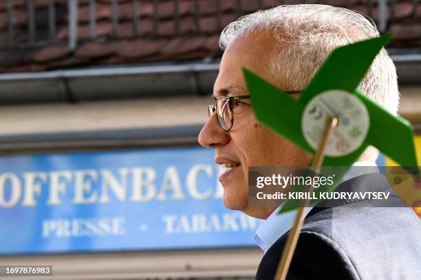 German Green Party's candidate Tarek Al-Wazir attends a pre-election event ahead state parliamentary elections on a market square in Offenbach,...