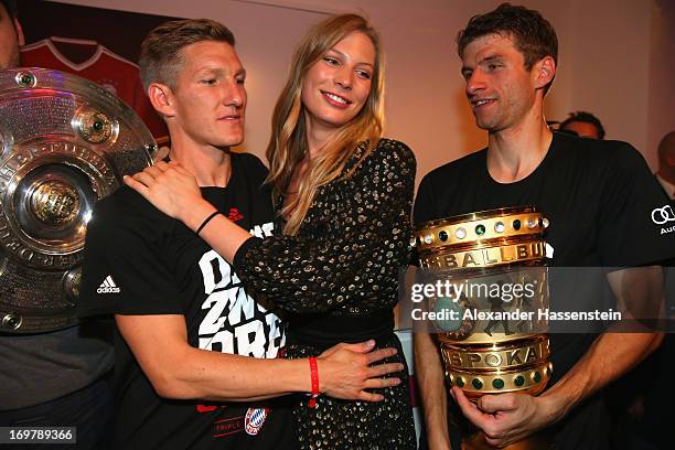 Bastian Schweinsteiger of FC Bayern Muenchen celebrates with Sarah Brandner and his team mate Thomas Mueller the FC Bayern Muenchen Champions party...