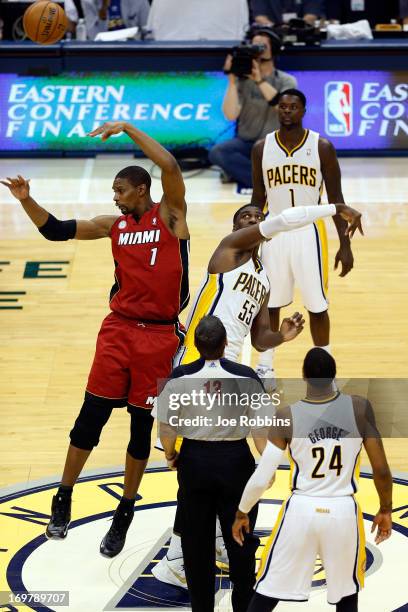 Chris Bosh of the Miami Heat wins the face-off against Roy Hibbert of the Indiana Pacers to start Game Six of the Eastern Conference Finals during...