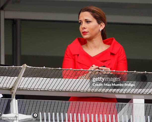 Princess Haya Bint Al Hussein holds some prayer beads whilst watching the racing as she attends Derby Day of the Investec Derby Festival at Epsom...