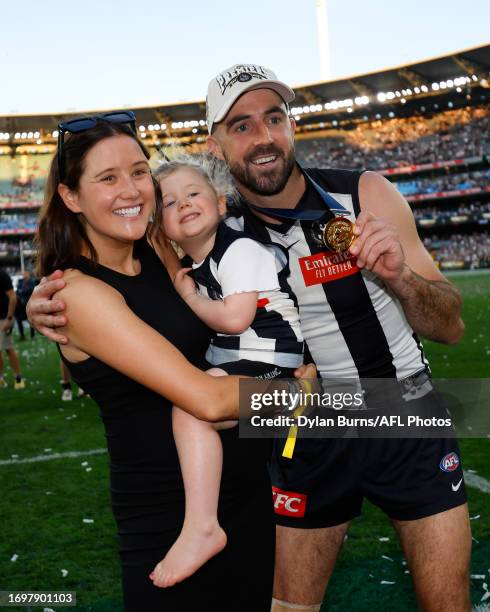 Steele Sidebottom of the Magpies poses for a photo with his wife Alisha and daughter Matilda during the 2023 AFL Grand Final match between the...