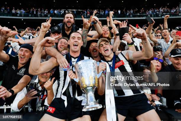 Darcy Cameron and Brayden Maynard of the Magpies celebrate with the premiership cup during the 2023 AFL Grand Final match between the Collingwood...