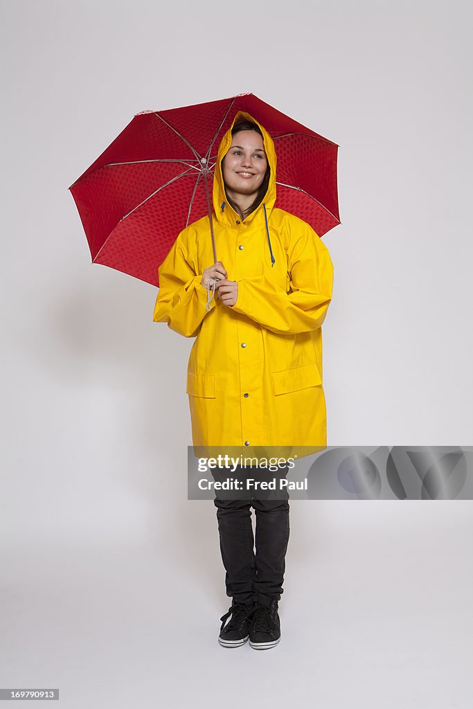 Young woman with raincoat and umbrella