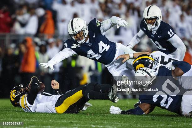 Cade McNamara of the Iowa Hawkeyes is sacked by Chop Robinson and Adisa Isaac of the Penn State Nittany Lions during the first half at Beaver Stadium...