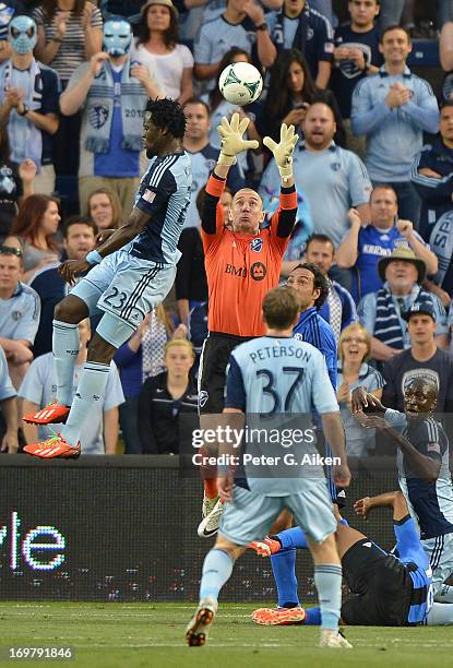 Goal keeper Troy Perkins of the Montreal Impact goes up to make a save from a head shot form forward Kei Kamara of Sporting Kansas City during the...