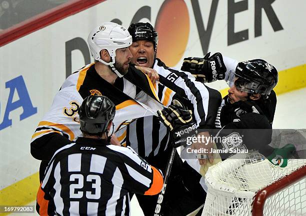 Linesman Jay Sharrers gets in between Zdeno Chara of the Boston Bruins and Sidney Crosby of the Pittsburgh Penguins in the second period during Game...