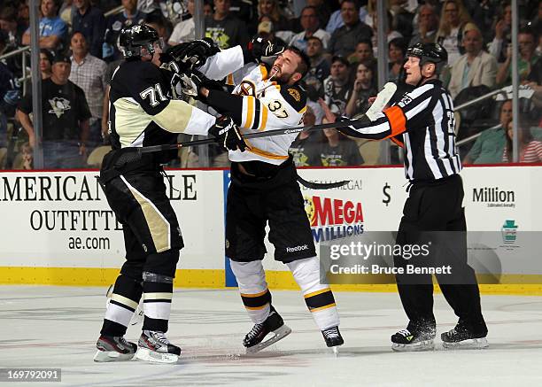 Evgeni Malkin of the Pittsburgh Penguins and Patrice Bergeron of the Boston Bruins fight towards the end of the second period during Game One of the...