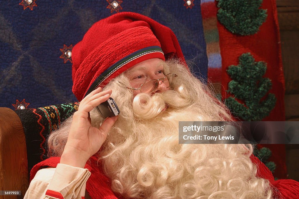 Santa Claus Takes A Call On His Mobile Phone