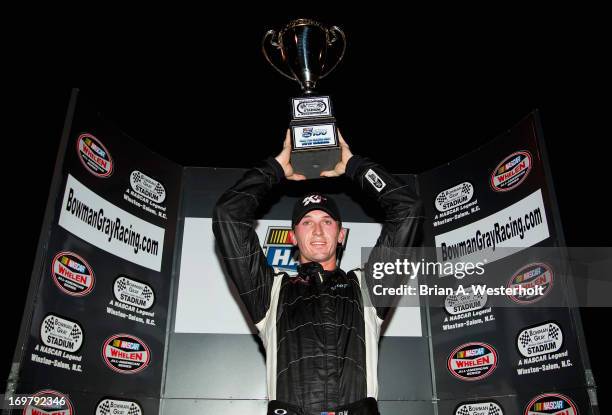 Ben Kennedy, driver of the Emco Gears/Mac Tools/Mechanix Wear Chevrolet holds up the trophy after winning the NASCAR K&N Pro Series East NASCAR Hall...