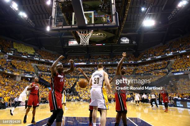 Joel Anthony of the Miami Heat and LeBron James react after a play at the basket against Tyler Hansbrough of the Indiana Pacers in Game Six of the...