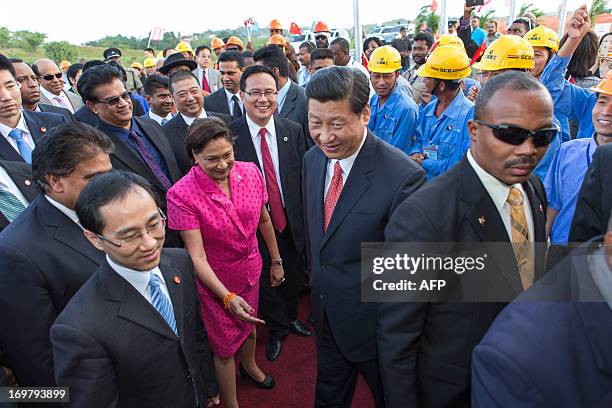 China's President Xi Jinping and Prime Minister of Trinidad and Tobago Kamla Persad-Bissessar arrive at the site of the Couva Children´s Hospital in...