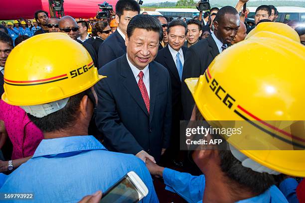 China's President Xi Jinping shake hands with Chinese construction workers at the site of the Couva Children´s Hospital in Port-of-Spain, Trinidad...