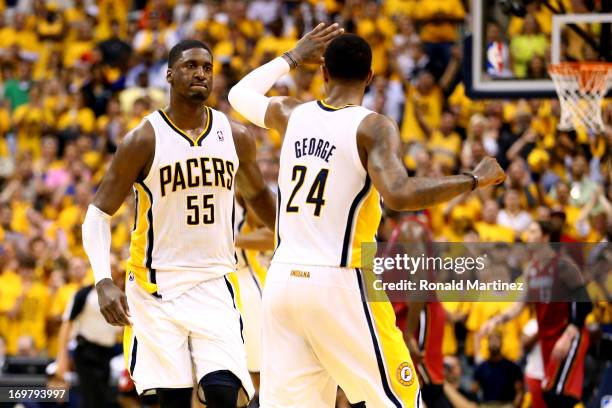 Roy Hibbert of the Indiana Pacers celebrates with teammate Paul George after scoring against the Miami Heat in Game Six of the Eastern Conference...