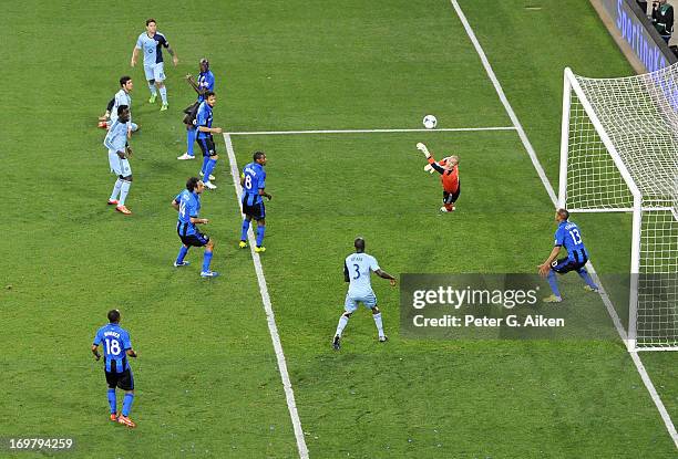 Goal keeper Troy Perkins of the Montreal Impact makes a diving save on a shot on goal against Sporting Kansas City during the second half on June 1,...