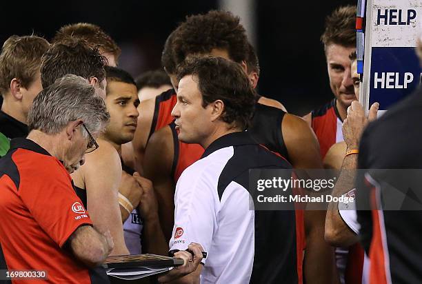 Saints coach Scott Watters speaks to his players during the round ten AFL match between the North Melbourne Kangaroos and the St Kilda Saints at...