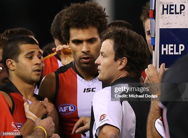 Saints coach Scott Watters speaks to Ahmed Saad and james Gwilt during the round ten AFL match between the North Melbourne Kangaroos and the St Kilda...